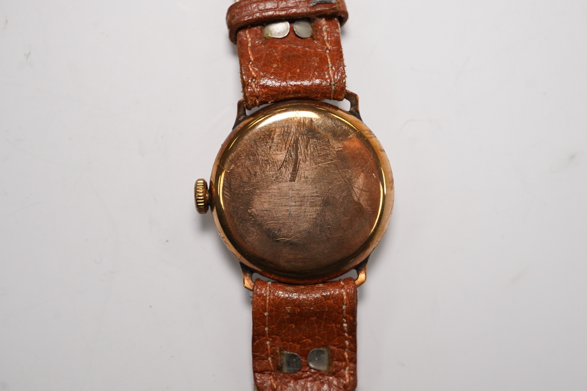 A gentleman's 1930's 9ct gold manual wind wrist watch, with Arabic dial and subsidiary seconds, case diameter 29mm, on a later leather strap. Condition - poor